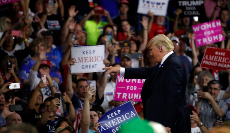 President Trump points to a supporter after speaking during a rally. 