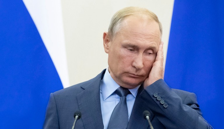 Russian President Vladimir Putin gestures during a news conference.