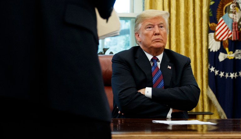 President Trump sits at his desk in the White House.