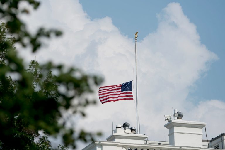 The American flag files at half-staff at the White House, Monday afternoon, Aug. 27, 2018, in Washington. Two days after Sen. John McCain's death, President Donald Trump says he respects the senator's "service to our country" and has signed a proclamation to fly the U.S. flag at half-staff until his burial. The flag atop the White House flew at half-staff over the weekend but was raised Monday and then lowered again amid criticism.