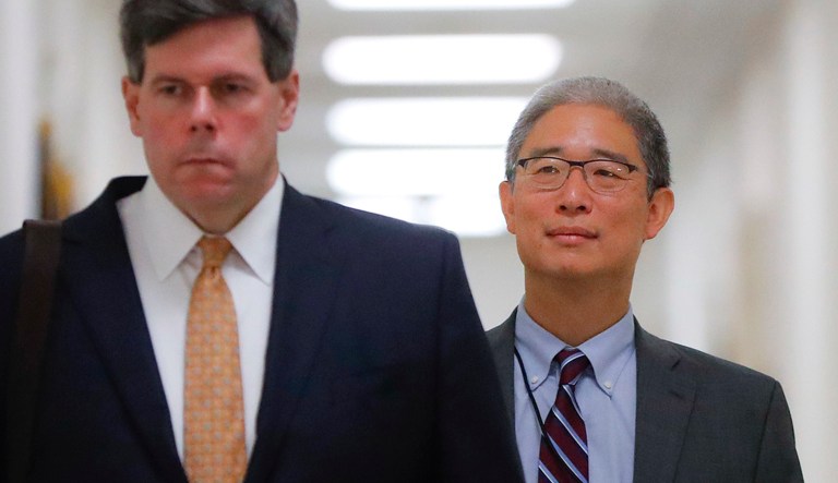 Bruce Ohr is escorted to a meeting room on Capitol Hill in D.C.