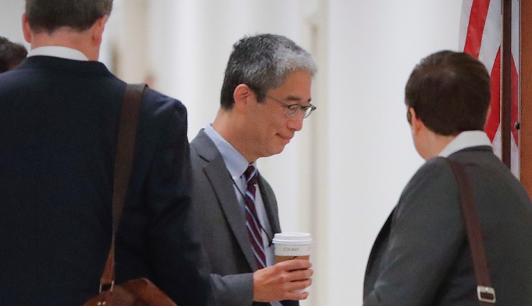 Bruce Ohr is escorted to a meeting room on Capitol Hill in D.C.