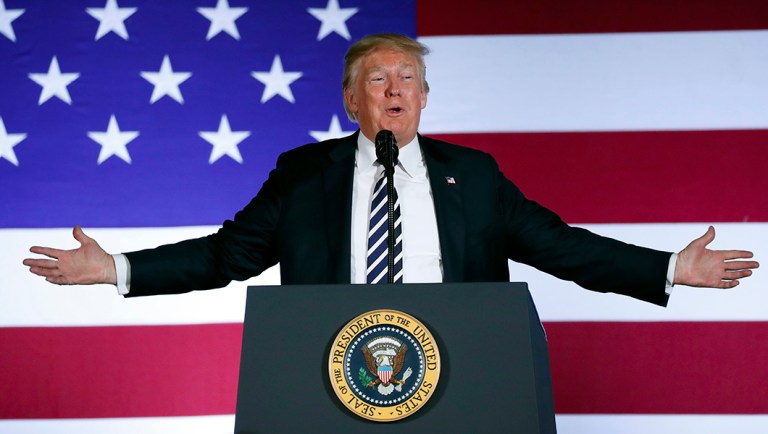 President Trump gestures while speaking at a Republican fundraiser at the Carmel Country Club.