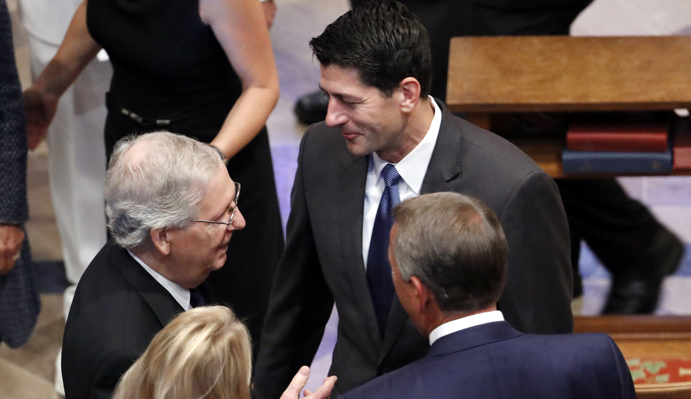 Senate Majority Leader Mitch McConnell, top left, talks to House speaker Paul Ryan as his wife Janna Ryan and former House Speaker John Boehner listen at a memorial service for Sen. John McCain, R-Ariz., at Washington National Cathedral in Washington on Saturday.