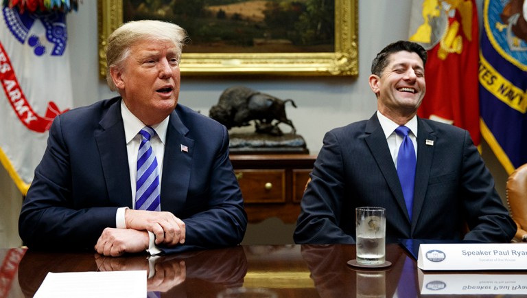 Speaker of the House Rep. Paul Ryan, R-Wis., laughs as he listens to President Trump speak during a meeting with Republican lawmakers.