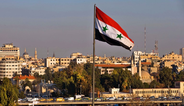 A Syrian national flag waves in Damascus, Syria.