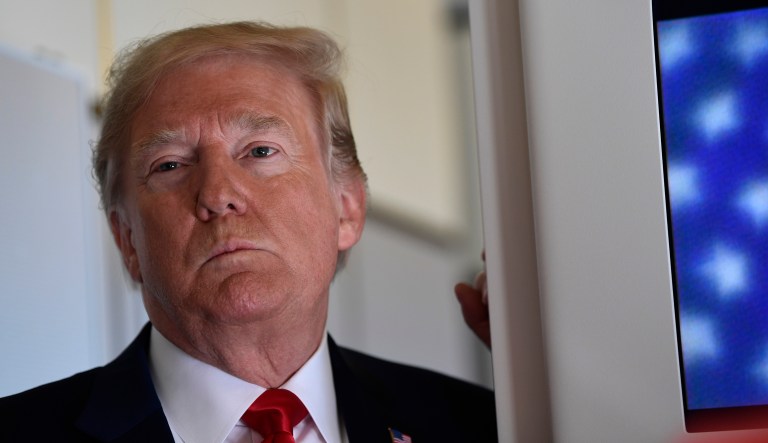 President Trump talks to reporters while in flight from Billings, Mont., to Fargo, N.D., Sept. 7, 2018.