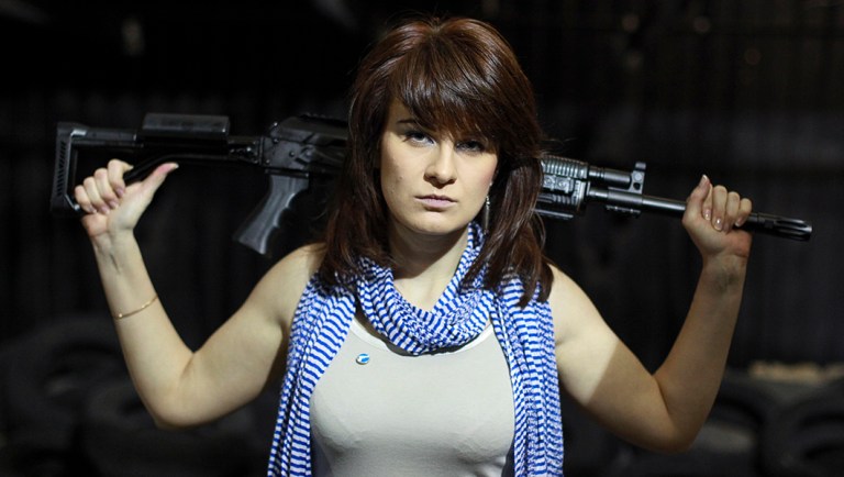 In this photo taken on Sunday, April 22, 2012, Maria Butina, a gun-rights activist, poses for a photo at a shooting range in Moscow, Russia.