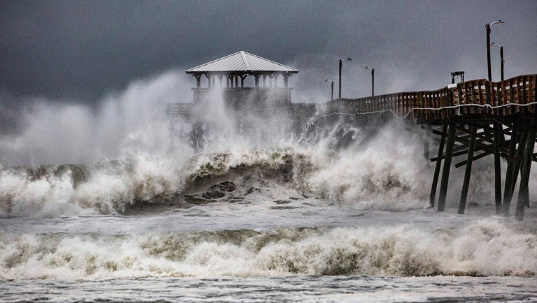 Waves slam the Oceana Pier & Pier House Restaurant in Atlantic Beach, N.C.
