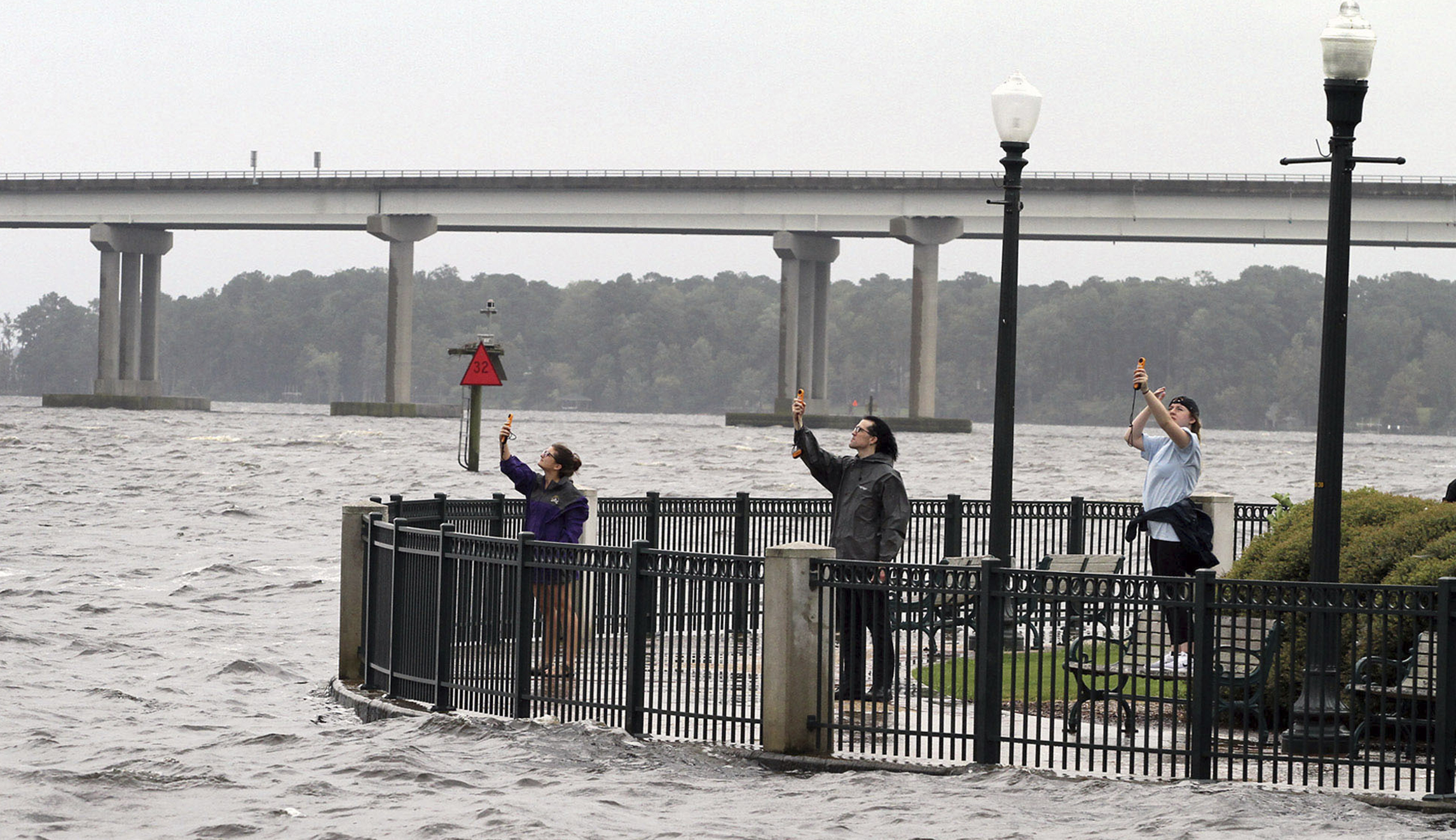 Students from a Coastal Storms class use anemometers to measure wind speeds at Union Point Park in New Bern, N.C., on Thursday.