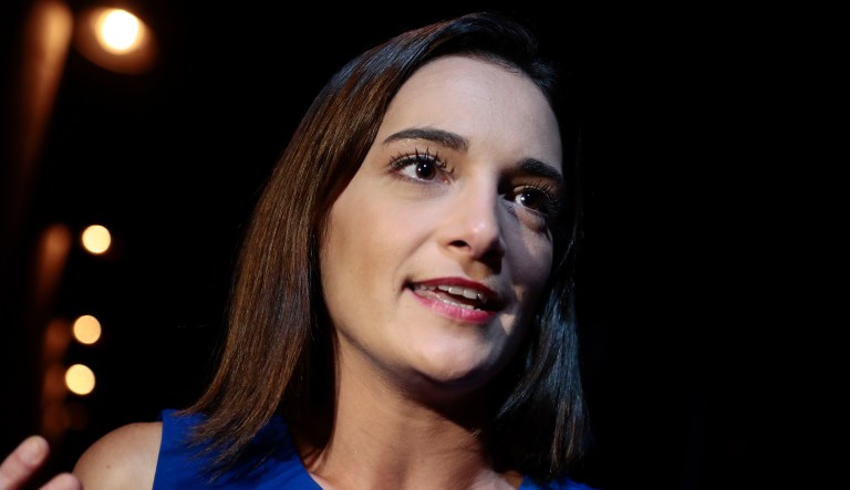 Julia Salazar answers questions during an interview after winning the Democratic primary over Martin Dilan in New York's 18th State Senate district race, Thursday, Sept. 13, 2018, in New York.