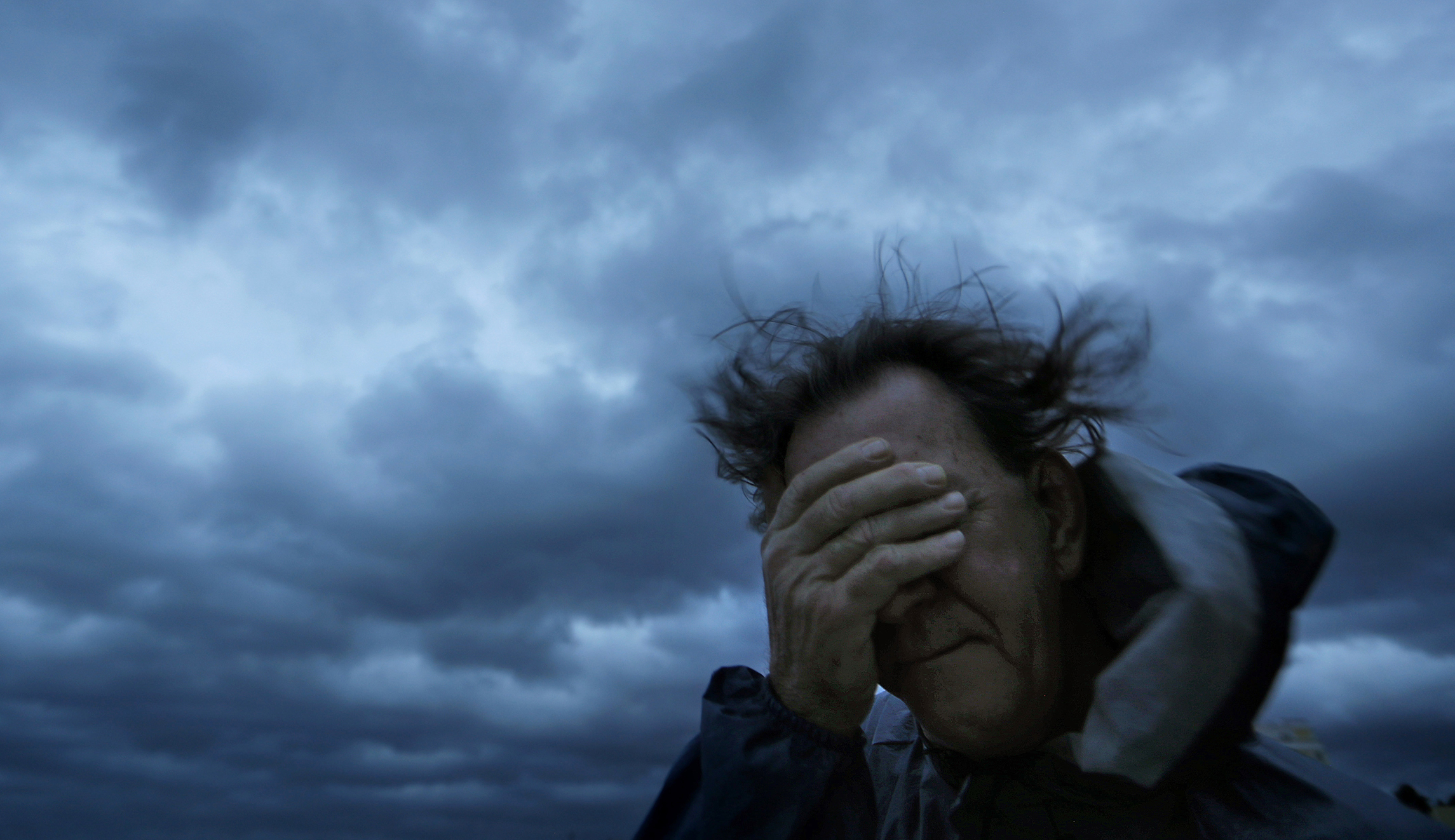 Russ Lewis covers his eyes from a gust of wind and a blast of sand as Hurricane Florence approaches Myrtle Beach, S.C., on Friday.