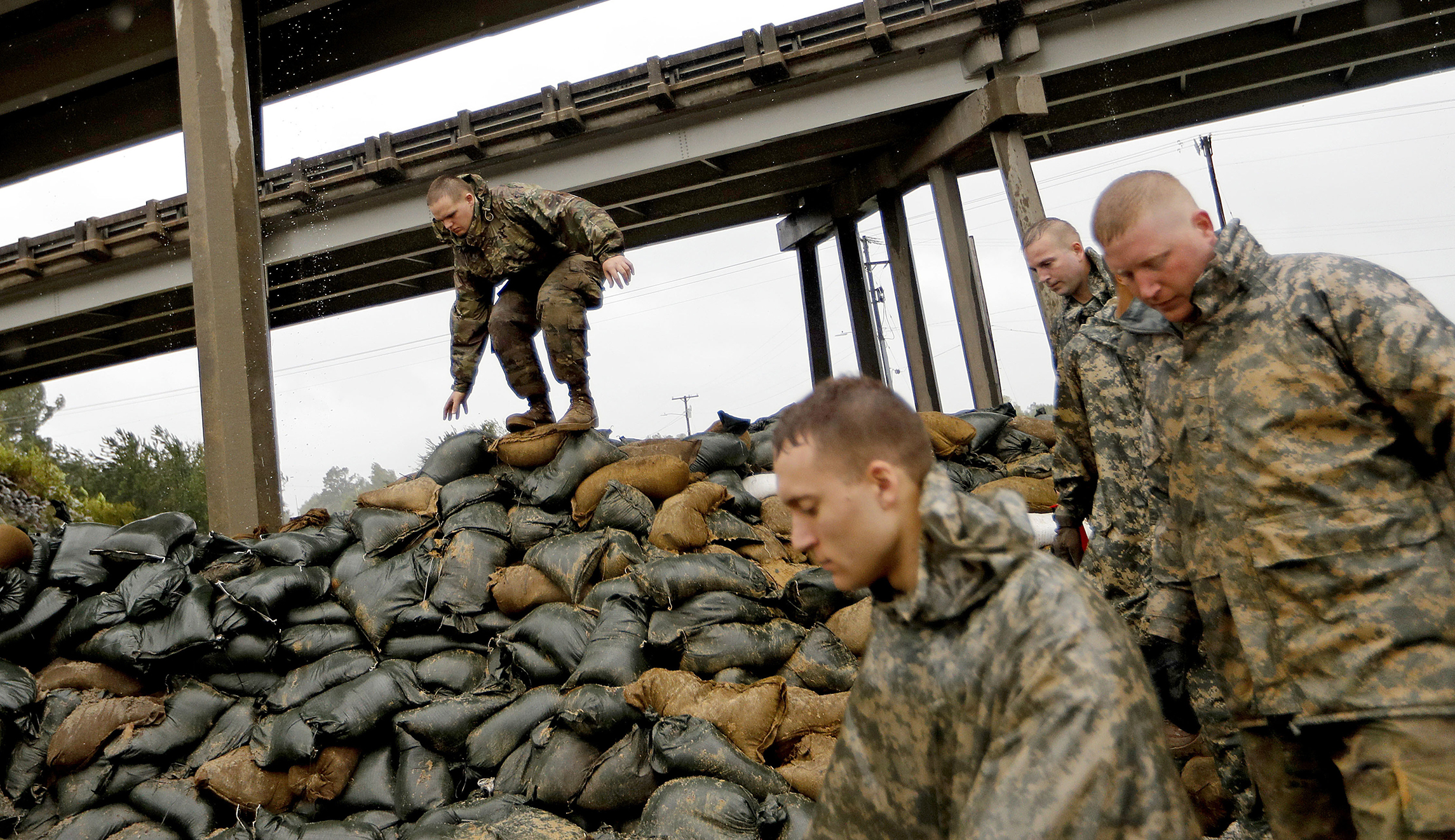 Members of the North Carolina National Guard finish stacking sand bags under a highway overpass near the Lumber River which is expected to flood from Hurricane Florence's rain in Lumberton, N.C., Friday.