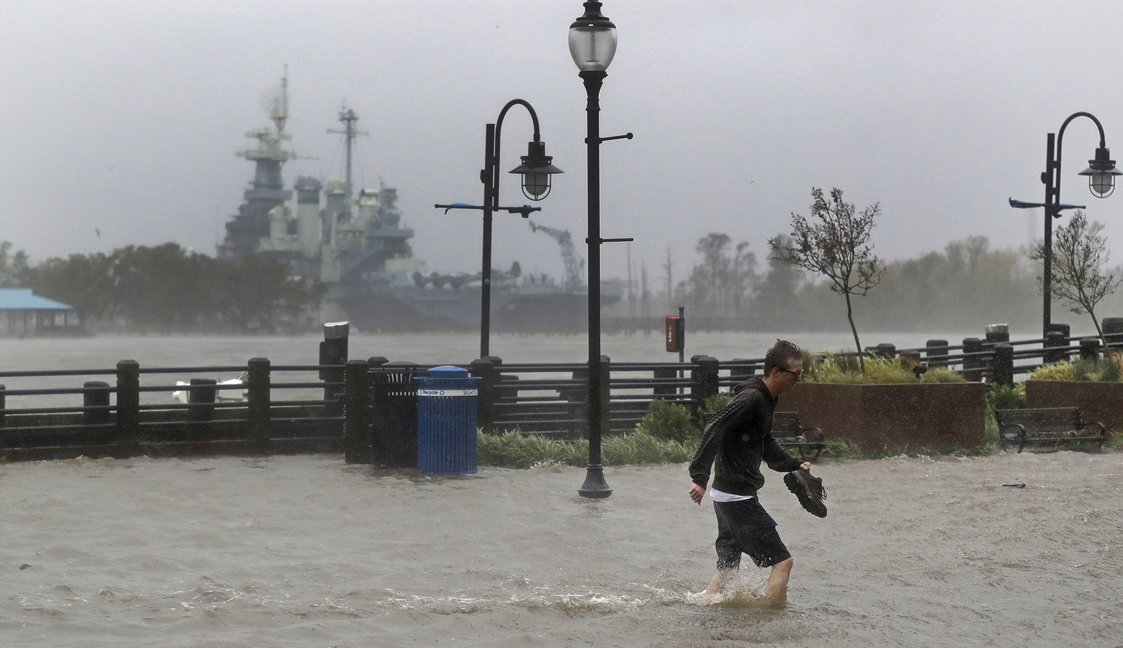 A man crosses a flooded street in downtown Wilmington, N.C., after Hurricane Florence made landfall Friday.
