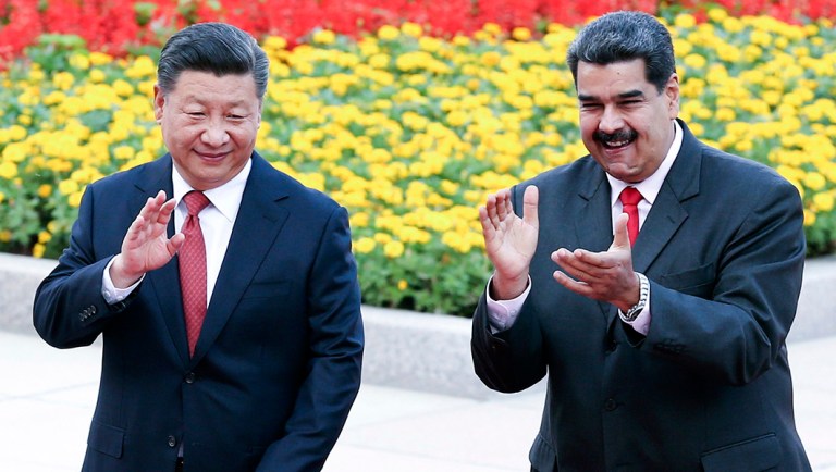 In this Friday, Sept. 14, 2018, photo released by China's Xinhua News Agency, Chinese President Xi Jinping, left, and Venezuela's President Nicolas Maduro react during a welcome ceremony.