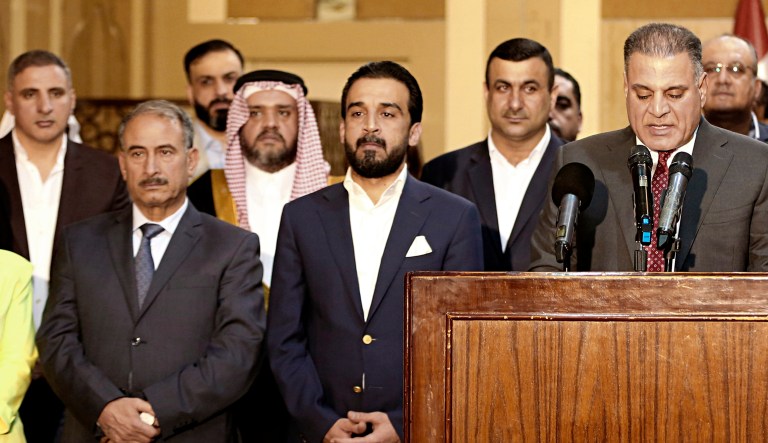Iraq's new Parliament Speaker Mohammed al-Halbousi, 37, center, and his political bloc hold a press conference In Baghdad, Iraq.