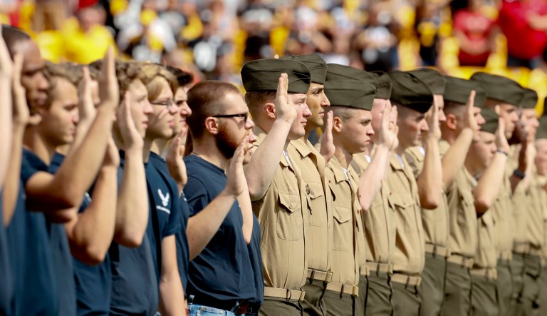 Military recruits take thier oath as they are sworn in at an NFL football game between the Pittsburgh Steelers and the Kansas City Chiefs, Sunday, Sept. 16, 2018, in Pittsburgh.
