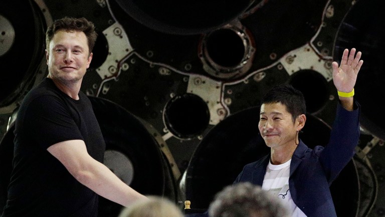 SpaceX founder and chief executive Elon Musk, left, shakes hands with Japanese billionaire Yusaku Maezawa, right, after announcing him as the first private passenger on a trip around the moon.