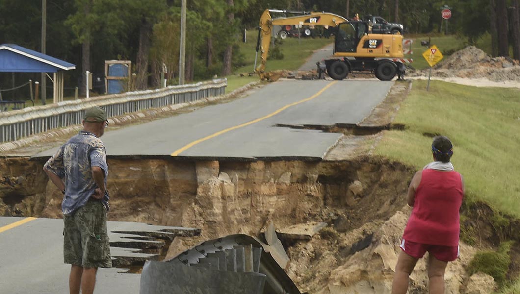 Mary and Phil Pongonis look at the damaged roadway from Hurricane Florence in Boiling Spring Lakes, N.C.