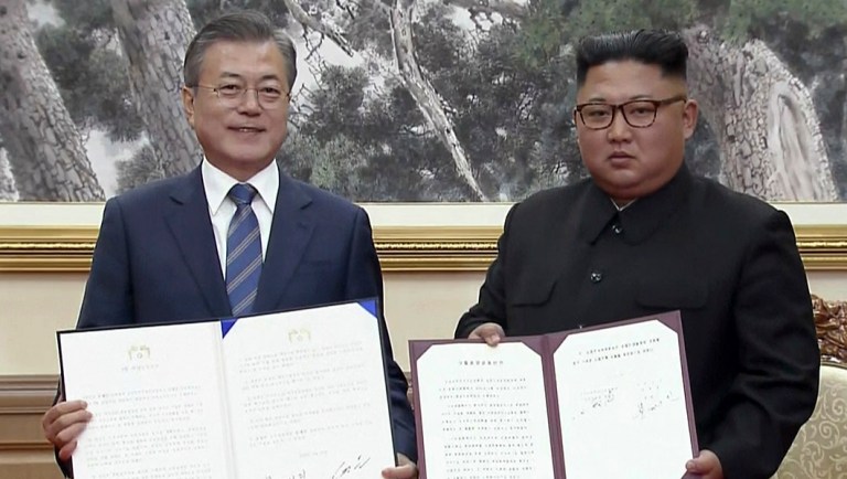 South Korean President Moon Jae-in, left, and North Korean leader Kim Jong Un pose after signing documents in Pyongyang, North Korea.