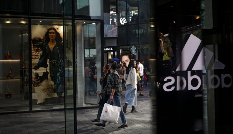 Chinese shoppers walk through the capital city's popular shopping mall in Beijing, Monday, Sept. 24, 2018. China raised tariffs Monday on thousands of U.S. goods in an escalation of its fight with President Donald Trump over technology policy and accused Washington of bullying Beijing and damaging the global economy.