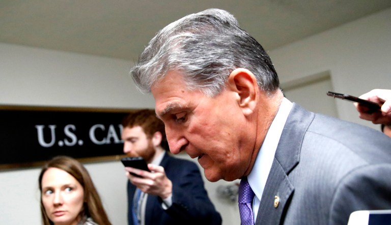 Sen. Joe Manchin, D-W.Va., talks with reporters as he walks on Capitol Hill in D.C.