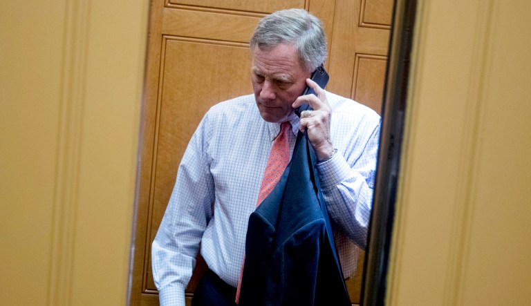 Sen. Richard Burr, R-N.C., speaks on a cellphone as he arrives at the Capitol in D.C.