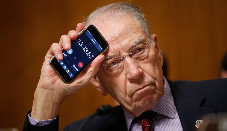 Senate Judiciary Committee Chairman Chuck Grassley of Iowa holds up a timer on a smartphone during a hearing on Supreme Court nominee Judge Brett Kavanaugh, Friday, Sept. 28, 2018, on Capitol Hill in Washington.