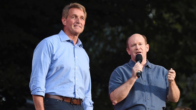 Sen. Jeff Flake, R-Ariz., left, and Sen. Chris Coons, D-Del., address the crowd at the 2018 Global Citizen Festival in Central Park.