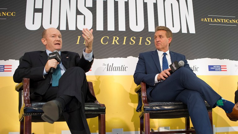 Sen. Jeff Flake, R-Ariz., right, and Sen. Chris Coons, D-Del., participate in an interview.
