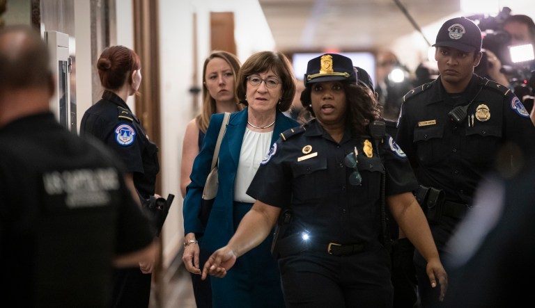 Sen. Susan Collins, R-Maine, is escorted by U.S. Capitol Police past waiting reporters trying to ask about Supreme Court nominee Brett Kavanaugh on Capitol Hill in Washington, Wednesday, Oct. 3, 2018.