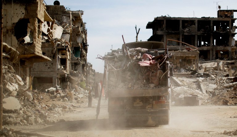 A truck removes rubble from the street in Damascus, Syria.