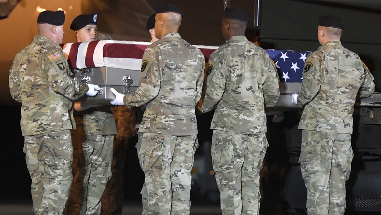 An Army carry team moves a transfer case containing the remains of Sgt. James A. Slape at Dover Air Force Base, Del.