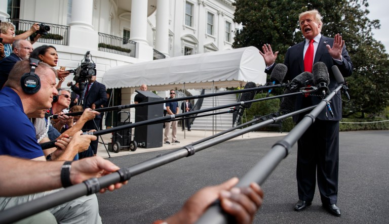 President Donald Trump speaks with reporters on the South Lawn of the White House, Monday, Oct. 8, 2018, in Washington.