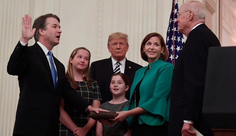 President Donald Trump, center, listens as retired Supreme Court Justice Anthony Kennedy, right, ceremonially swears-in Supreme Court Justice Brett Kavanaugh, left, in the East Room of the White House in Washington, Monday, Oct. 8, 2018. Kavanaugh's wife Ashley watches, second from right with daughters Margaret, left, and Liza.