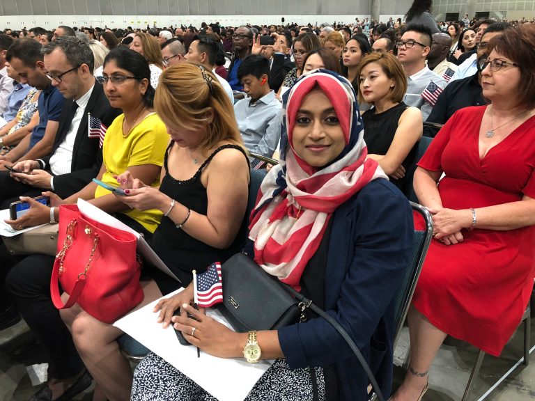 In this Sept. 18, 2018 photo Sameeha Alkamalee Jabbar, a 38-year-old from Orange County sits during a naturalization ceremony in Los Angeles.