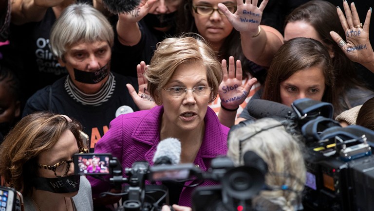 Sen. Elizabeth Warren, D-Mass., greets womens' rights activists in the Hart Senate Office Building.
