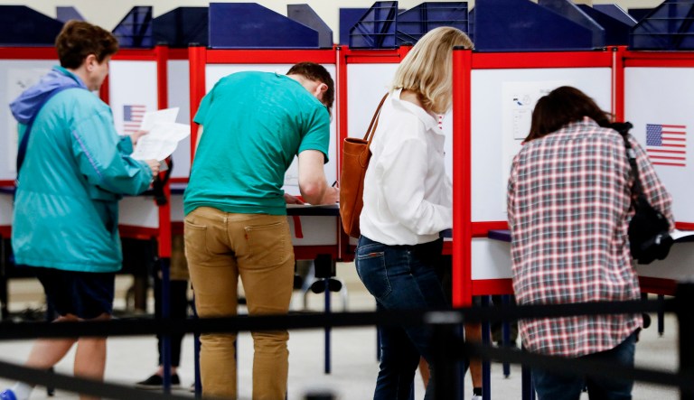 Voters fill out their ballots at the Hamilton County Board of Elections on the first day of early voting on Oct. 10, 2018, in Cincinnati.
