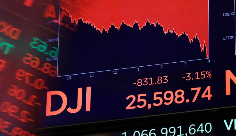 This Wednesday, Oct. 10, 2018, file photo shows a screen above the floor of the New York Stock Exchange showing the closing number of the Dow Jones Industrial Average.