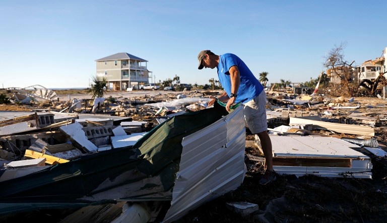 Mike Jackson sifts through debris looking for remnants of his home, which was destroyed by Hurricane Michael in Mexico Beach, Fla., Saturday.