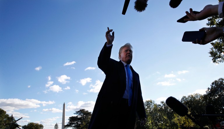 President Donald Trump answers questions from members of the media after leaving the Oval Office of the White House, Saturday, Oct. 13, 2018, in Washington, en route to Kentucky.
