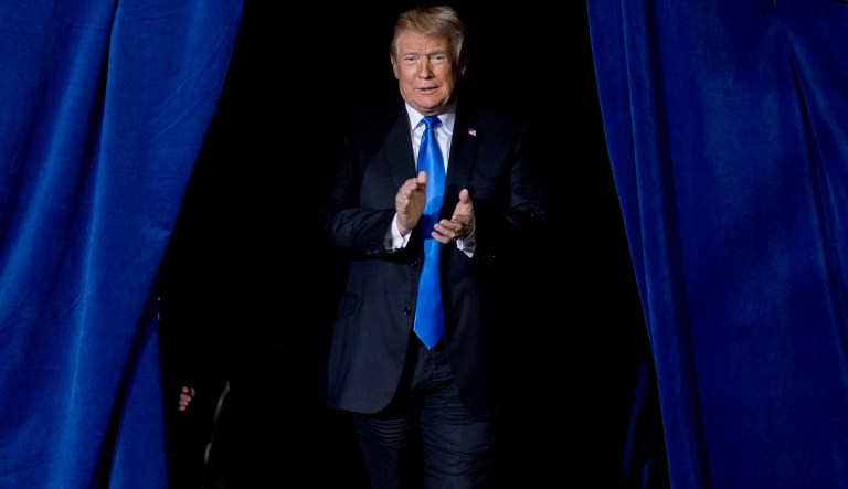 President Donald Trump takes the stage at a rally at Alumni Coliseum in Richmond, Ky., Saturday, Oct. 13, 2018.