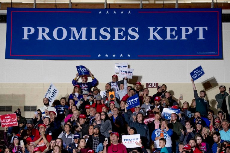 Members of the audience cheer under a large banner that reads "Promises Kept" as President Donald Trump speaks at a rally at Alumni Coliseum in Richmond, Ky., Saturday, Oct. 13, 2018.