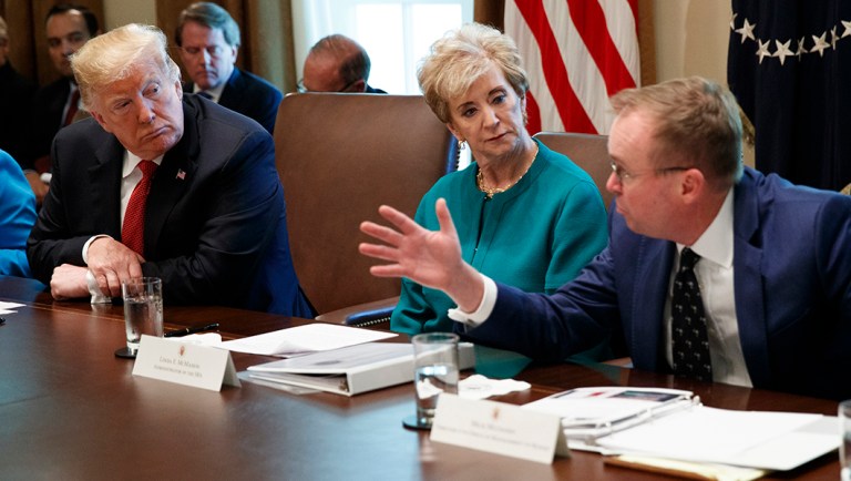 President Trump, left, and Small Business Administration administrator Linda McMahon, center, listen as Director of the Office of Management and Budget Mick Mulvaney speaks during a cabinet meeting.