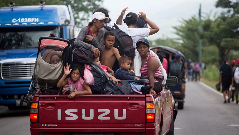 Honduran migrants who are traveling to the U.S. as a group get a free ride in the back of a driver's truck as they make their way through Zacapa, Guatemala.