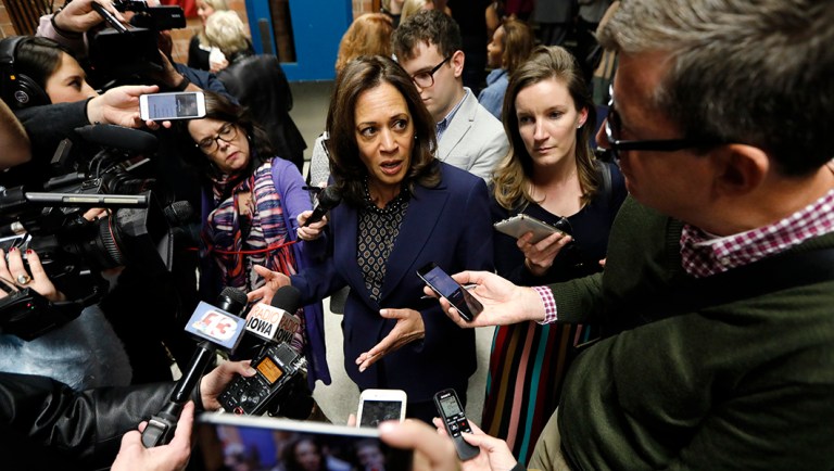 U.S. Sen. Kamala Harris, D-Calif., center, speaks to reporters following a get out the vote rally.
