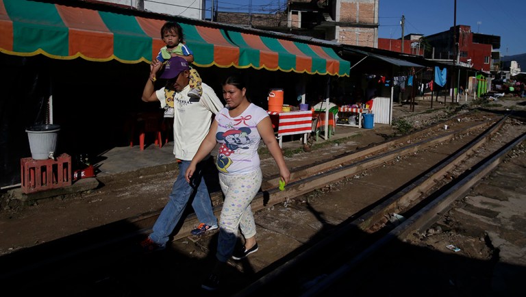 Central American migrants traveling with a caravan to the U.S. make their way to the main square in Huixtla, Mexico.