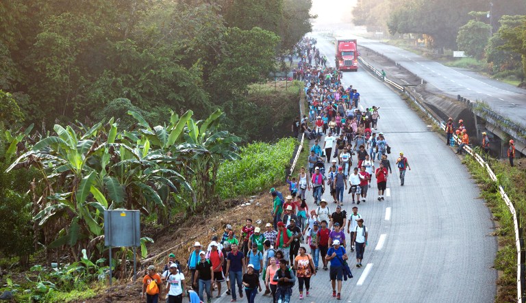 Central American migrants traveling with a caravan to the U.S. make their way to Mapastepec, Mexico, on Wednesday. Thousands of Central American migrants renewed their hoped-for march to the United States on Wednesday, setting out before dawn with plans to travel another 45 miles (75 kilometers) of the more than 1,000 miles that still lie before them. 
