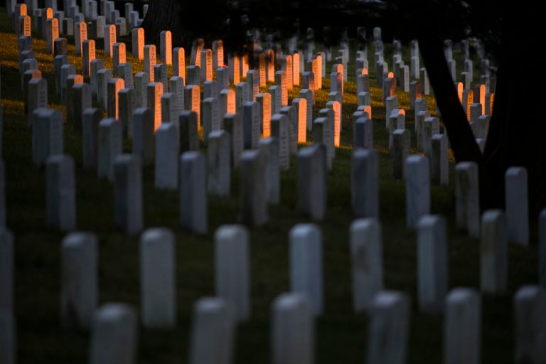 The rising sun illuminates headstones at Arlington National Cemetery, Thursday, Oct. 25, 2018 in Arlington, Va.
