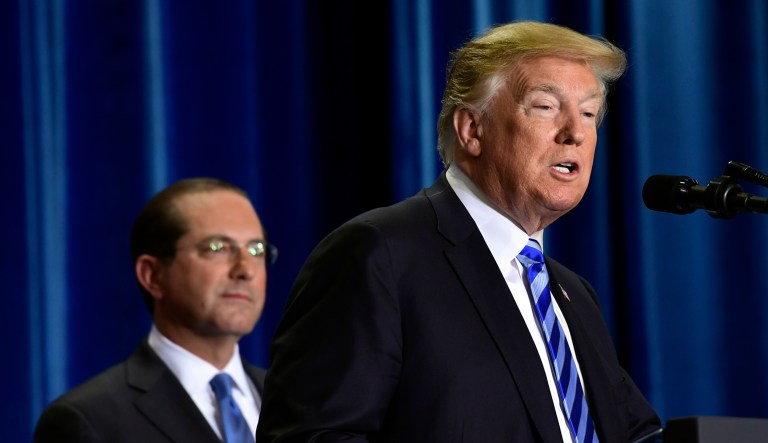 President Trump speaks during a visit to the Department of Health and Human Services in D.C. HHS Secretary Alex Azar listens at left. 